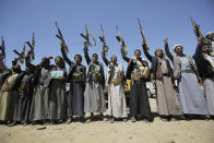 FILE - In this Saturday Sept. 21, 2019 file photo, Shiite Houthi tribesmen hold their weapons as they chant slogans during a tribal gathering showing support for the Houthi movement, in Sanaa, Yemen. On Wednesday, April 8, 2020, the Saudi-led coalition fighting the Iranian-backed Houthi rebels in Yemen announced that its forces would begin a cease-fire starting at midnight, in what could pave the way for the first direct peace talks between the two sides that have been at war for more than five years. (AP Photo/Hani Mohammed)