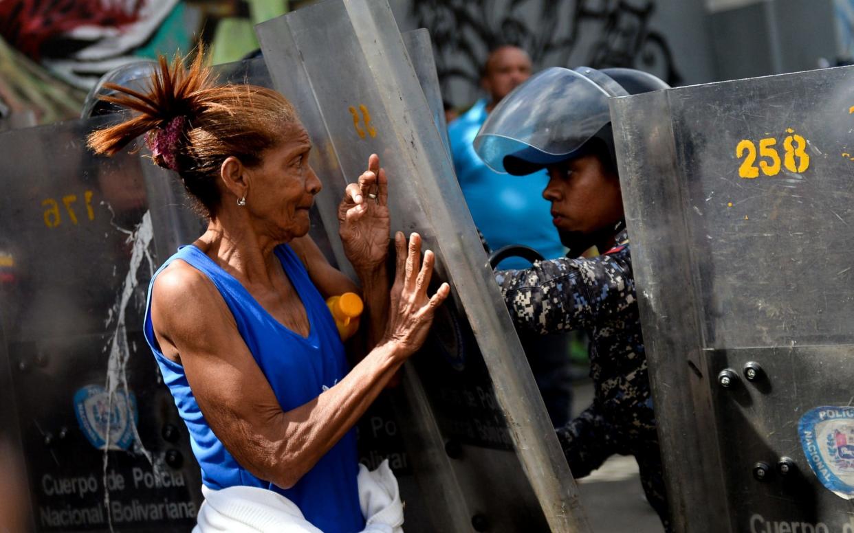 Hundreds of protesters clashed with armed police after their government-subsidized hams were not delivered in time for Christmas - AFP