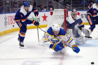 New York Islanders defenseman Noah Dobson (8) upends Buffalo Sabres right wing Kyle Okposo (21) during the third period of an NHL hockey game, Saturday, March 25, 2023, in Elmont, N.Y. The Sabres won 2-0.(AP Photo/Mary Altaffer)