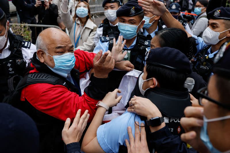 A supporter scuffles with police the West Kowloon Magistrates' Courts building during the hearing of the 47 pro-democracy activists charged with conspiracy to commit subversion under the national security law, in Hong Kong