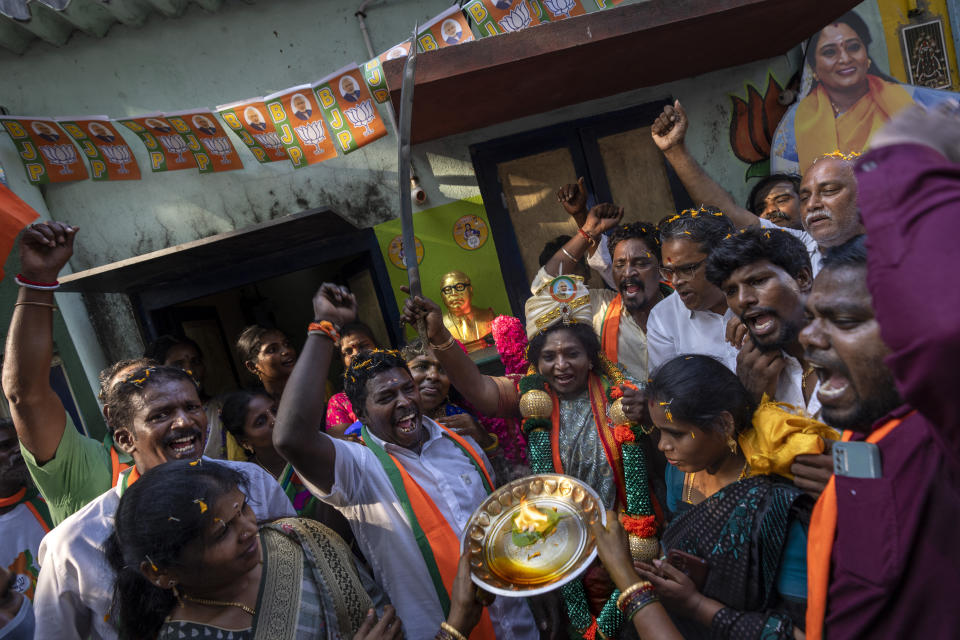 Supporters shout slogans as Bharatiya Janata Party (BJP) candidate Tamilisai Soundararajan, center, brandishes a sword presented to her during an election campaign rally ahead of country's general elections, in the southern Indian city of Chennai, April 14, 2024. (AP Photo/Altaf Qadri)