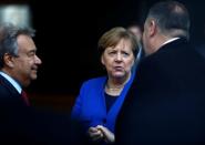 German Chancellor Angela Merkel and United Nations Secretary-General Antonio Guterres welcome U.S. Secretary of State Mike Pompeo at the Libya summit in Berlin