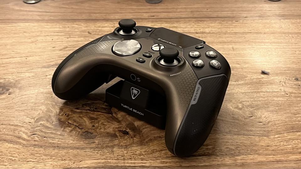 The Turtle Beach Stealth Ultra controller place on its stand on a wooden surface.