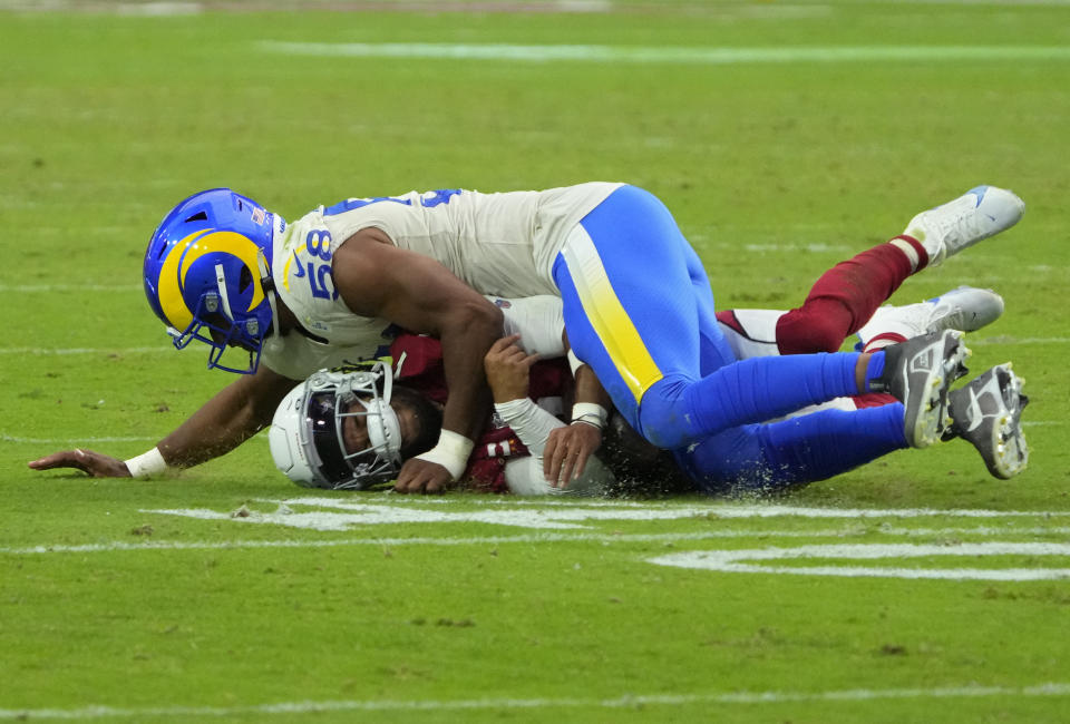 Los Angeles Rams linebacker Justin Hollins (58) tackles Arizona Cardinals quarterback Kyler Murray (1) during the second half of an NFL football game, Sunday, Sept. 25, 2022, in Glendale, Ariz. (AP Photo/Rick Scuteri)