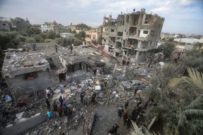 Palestinians inspect the rubble of destroyed buildings after heavy Israeli bombardment of the Al-Maghazi camp in the central Gaza Strip. The Hamas-controlled Ministry of Health said more than 70 people were killed. Mohammed Talatene/dpa