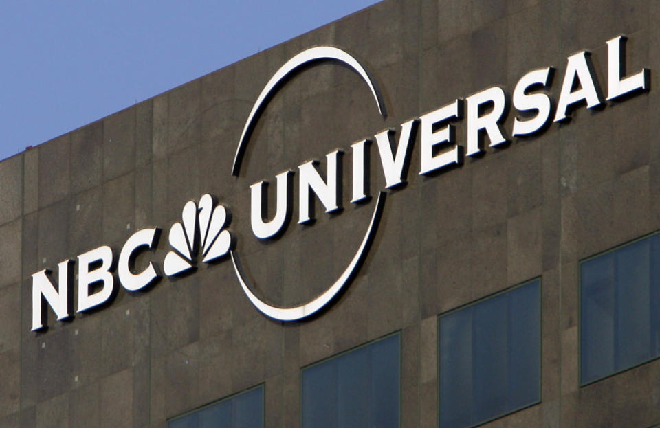 FILE - This Dec. 3, 2009, file photo, the NBC Universal logo hangs on a building in Los Angeles. Comcast’s NBCUniversal says its upcoming streaming service will be called Peacock, in an homage to NBC’s logo, and will be the home for some of the company’s most popular shows, including “Parks and Recreation,” “The Office” and “30 Rock.” (AP Photo/Jae C. Hong, File)