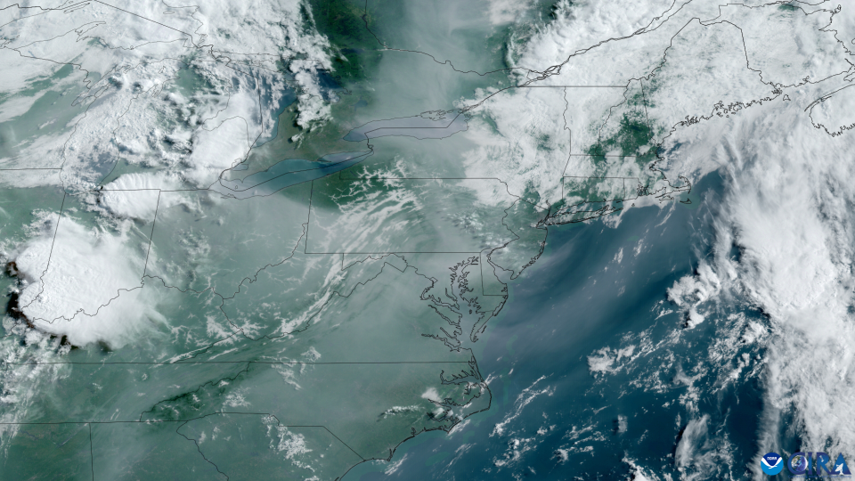 an image of earth taken by a satellite, showing white wispy clouds over blue oceans and green landmasses