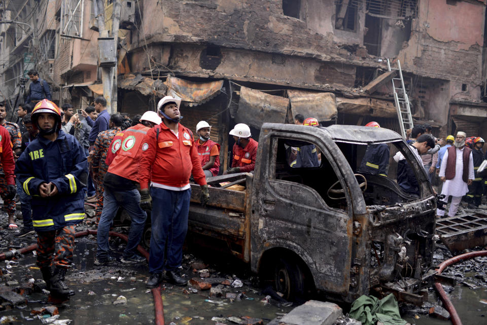 Locals and firefighters gather around buildings that caught fire late Wednesday in Dhaka, Bangladesh, Feb. 21, 2019. (Photo: Mahmud Hossain Opu/AP)