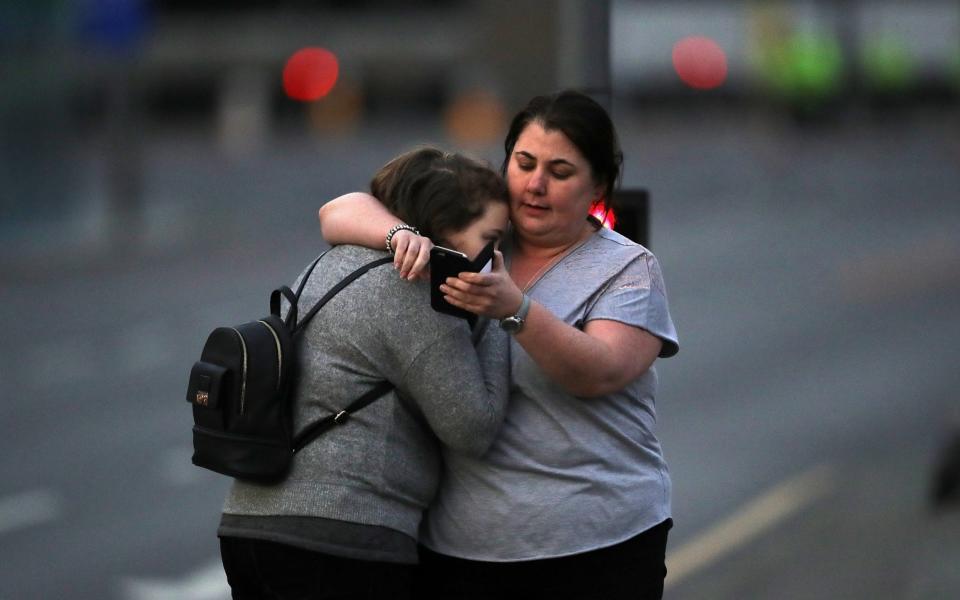 Ariana Grande concert attendees Vikki Baker and her daughter Charlotte, aged 13, leave the Park Inn where they were given refuge after last night's explosion at Manchester Arena - Credit: Getty