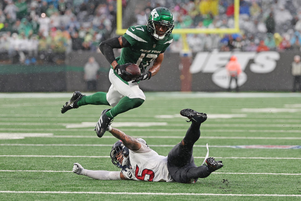 EAST RUTHERFORD, NEW JERSEY – DECEMBER 10: Garrett Wilson #17 of the New York Jets jumps over <a class="link " href="https://sports.yahoo.com/nfl/players/33992" data-i13n="sec:content-canvas;subsec:anchor_text;elm:context_link" data-ylk="slk:Jalen Pitre;sec:content-canvas;subsec:anchor_text;elm:context_link;itc:0">Jalen Pitre</a> #5 of the <a class="link " href="https://sports.yahoo.com/nfl/teams/houston/" data-i13n="sec:content-canvas;subsec:anchor_text;elm:context_link" data-ylk="slk:Houston Texans;sec:content-canvas;subsec:anchor_text;elm:context_link;itc:0">Houston Texans</a> during the third quarter at MetLife Stadium on December 10, 2023 in East Rutherford, New Jersey. (Photo by Al Bello/Getty Images)