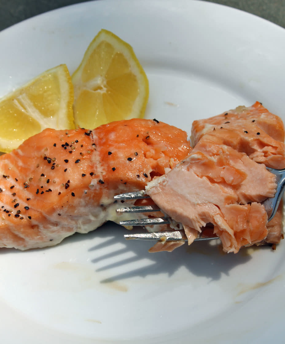 Flaky salmon on a fork.