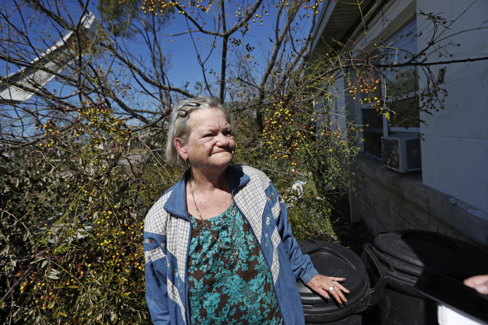 Mary Frances Parrish reacts outside her heavily damaged home, in the aftermath of Hurricane Michael in Panama City, Fla., Saturday, Oct. 13, 2018. She didn't leave the storm because her car was broken down, she didn't have a place to go and if she did she didn't have the money for it. She is caring for her terminally ill son who lives with her. (AP Photo/Gerald Herbert)