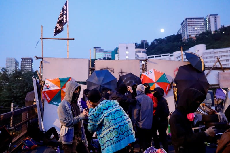 Anti-government protesters scout at a makeshift gate during a standoff with riot police at the Chinese University of Hong Kong, Hong Kong