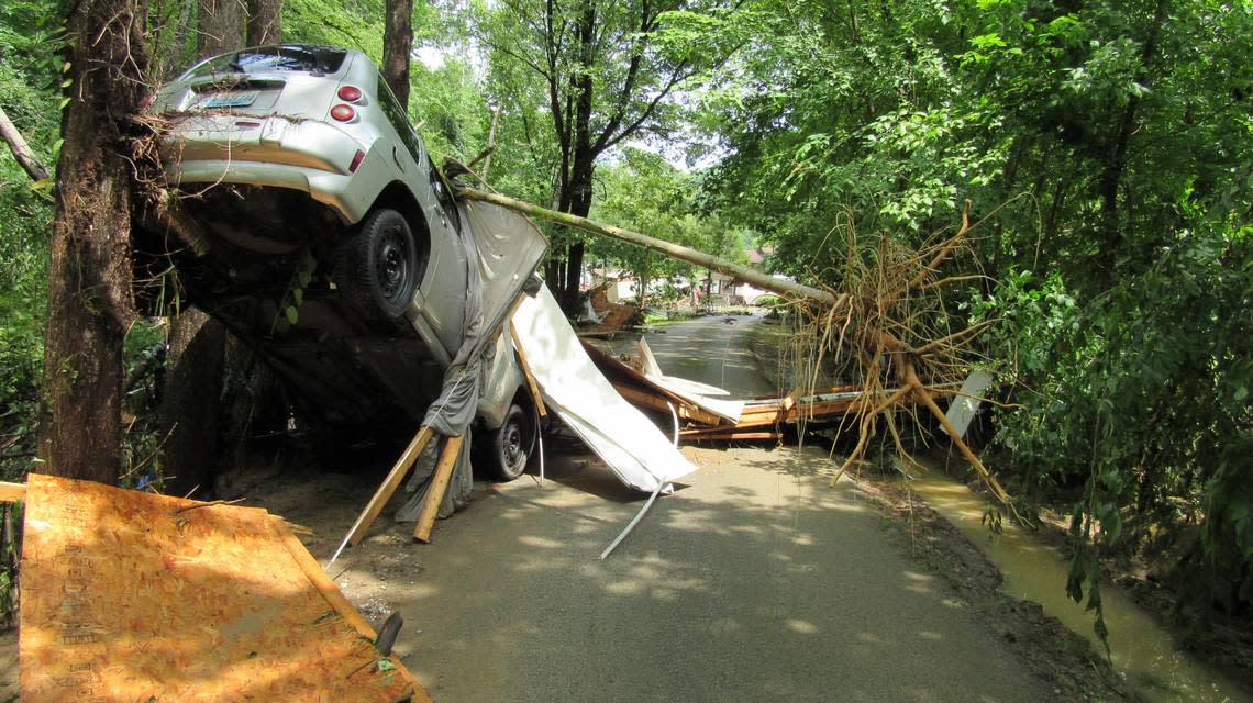 A flooded creek in Perry County, Ky., pushed a car against a tree in the Grapevine community on July 28, 2022.