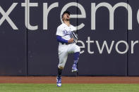 Los Angeles Dodgers right fielder Mookie Betts celebrates after robbing Atlanta Braves' Marcell Ozuna of a home during the fifth inning in Game 6 of a baseball National League Championship Series Saturday, Oct. 17, 2020, in Arlington, Texas. (AP Photo/Tony Gutierrez)
