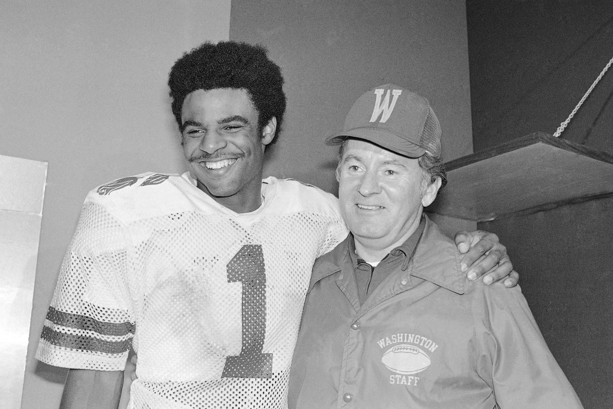 Washington Huskies quarterback Warren Moon poses with coach Don James after the Rose Bowl in Pasadena, Jan. 2, 1978.