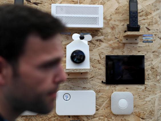 An attendee passes a display of Nest products during Google I/O 2016 at Shoreline Amphitheatre on 19 May, 2016 in Mountain View, California (Getty Images)