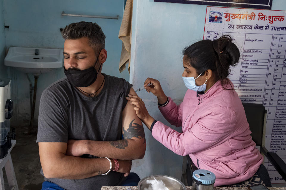 A man closes his eyes as he receives a Covishield vaccine for COVID-19 at a Primary Health Centre in Dharmsala, India, Friday, Dec. 3, 2021. (AP Photo/Ashwini Bhatia)