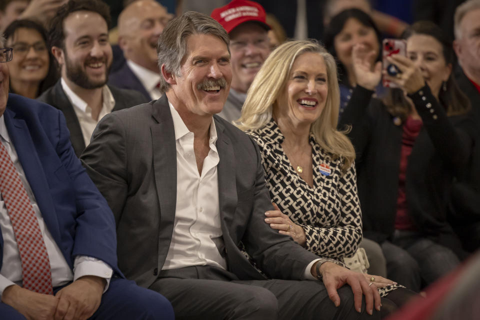 With his wife Sharon at his side Madison, Wis., businessman and Republican U.S. Senate candidate, Eric Hovde smile and laugh after being acknowledged, Tuesday April 2, 2024, at a former President Donald Trump rally in Green Bay, Wis. The Wisconsin Senate race between Democratic Sen. Tammy Baldwin and Republican Eric Hovde is setting up as one of the most competitive and expensive Senate races in the country. (AP Photo/Mike Roemer)
