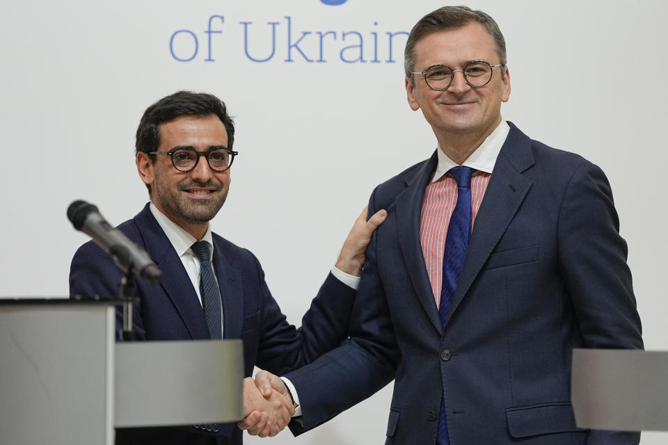 Ukraine's Foreign Minister Dmytro Kuleba, right, shakes hands with his French counterpart Stephane Sejourne after their joint press conference in Kyiv, Ukraine, Saturday, Jan. 13, 2024. (AP Photo/Efrem Lukatsky)