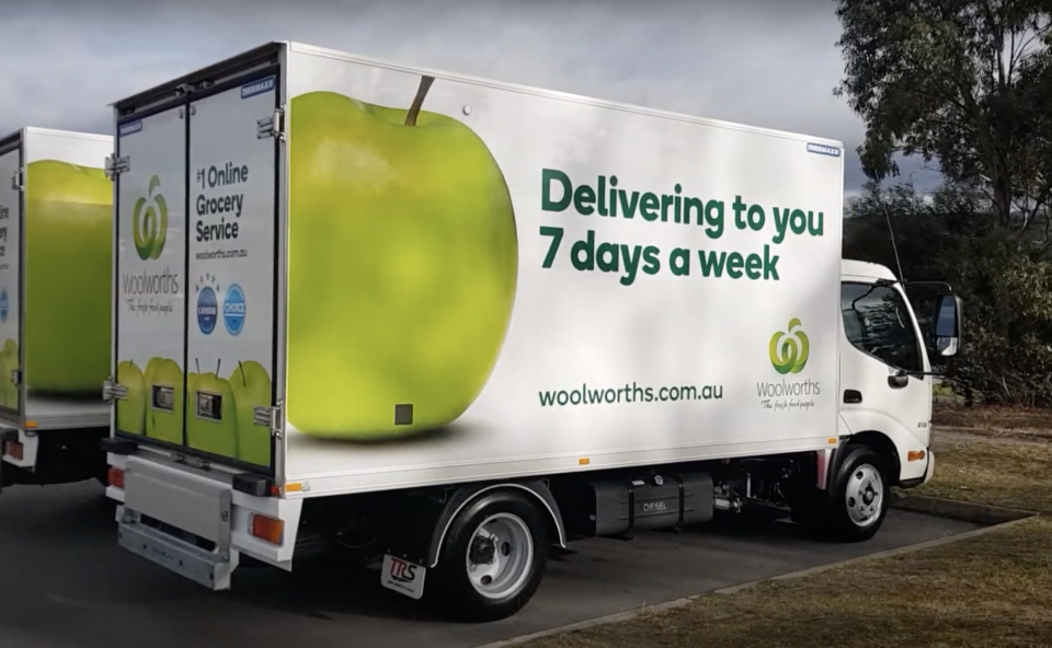 Woolworths delivery truck shown in car park.