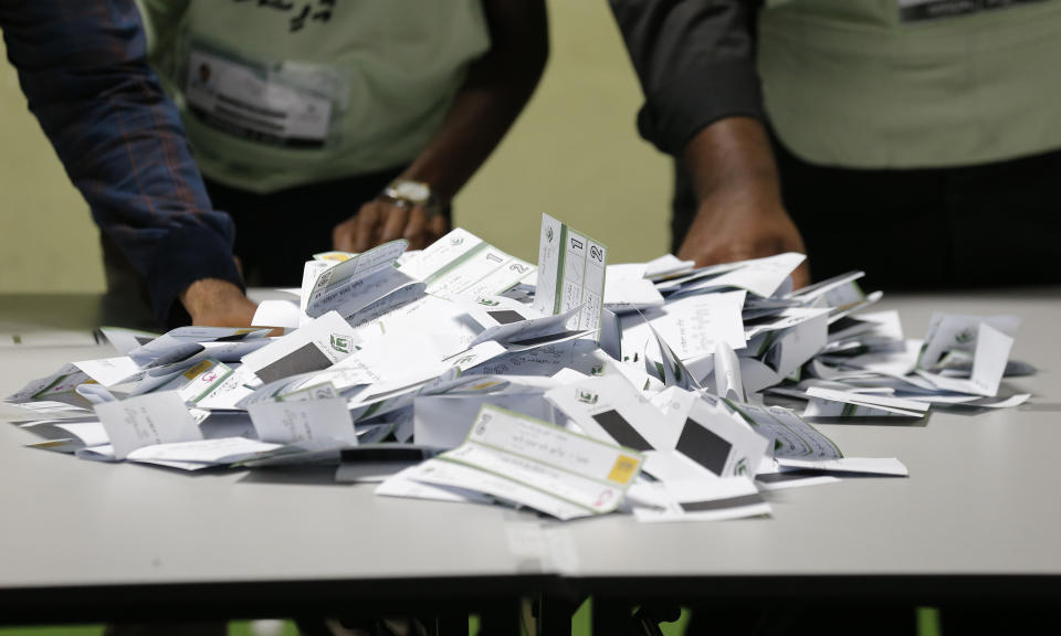 Maldivian polling workers prepare to count ballots at the end of the presidential election day in Male, Maldives, Sunday, Sept. 23, 2018. As officials began tabulating votes after the polls closed at 7 p.m., people in the Maldives and observers outside the tiny, tropical South Asian country waited for the results to see whether the opposition's cries of a rigged vote would be validated. (AP Photo/Eranga Jayawardena)