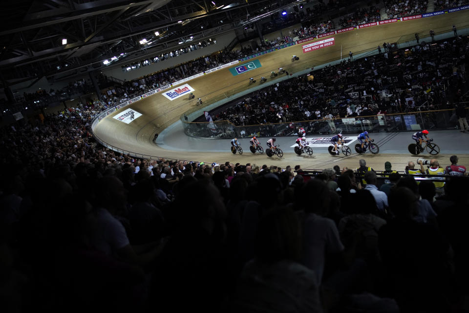 Riders compete during the Women's Madison race, at the National Velodrome in Saint-Quentin-en-Yvelines, west of Paris, France, Saturday, Oct. 15, 2022. The venue will host the track cycling events for the Paris 2024 Olympic Games. (AP Photo/Christophe Ena, File)