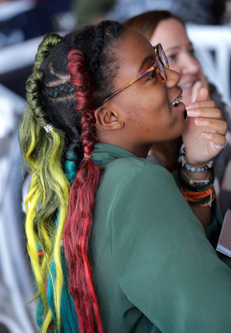 Ashley Nelson, 14, of Manitowoc participates in a Black history quiz wearing braids with colorful extensions during the Afro Hair Fair Saturday, February 25, 2023, at Poplar Hall in Appleton, Wis. Dan Powers/USA TODAY NETWORK-Wisconsin. 