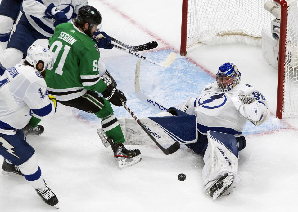 Tampa Bay Lightning goalie Andrei Vasilevskiy (88) makes the save on Dallas Stars' Tyler Seguin (91) during the third period of an NHL Stanley Cup finals hockey game in Edmonton, Alberta, on Monday, Sept. 28, 2020. (Jason Franson/The Canadian Press via AP)