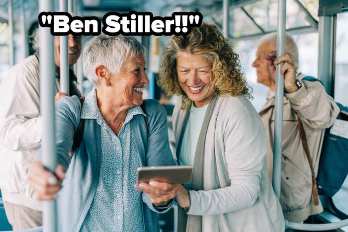 two women on public transportation looking at a tablet and the words "Ben Stiller!"