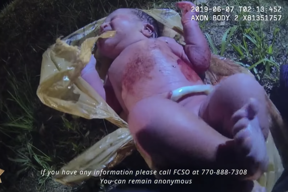 A sheriff’s office has released part of a body-cam video from the night an officer rescued a newborn baby girl who was found abandoned and wrapped in a plastic bag earlier this month. According to the Forsyth County Sheriff’s Office in Georgia, the hope is that the video will lead to credible information regarding the identity of the infant, who was found on 6 June.“The Forsyth County Sheriff’s Office is continuing to aggressively investigate and to follow leads regarding Baby India,” the department wrote on Facebook. “As of today, we are still receiving tips from across the country on the possible identity of Baby India."In the video, the officer can be seen ripping open a plastic bag to uncover a crying baby whose umbilical cord is still attached. The infant, who authorities named India, can later be seen wrapping its hand around the finger of one of the deputies on the scene. After performing first aid, the infant was taken to the hospital. According to the family who’d originally reported to police what sounded like a crying baby near their home in Forsyth County, finding the child was an “act of God”.Speaking to WSBTV’s Channel 2, Alan Ragatz said his teenage daughters were the ones who’d first heard the baby’s cries. After convincing their father that what they had heard wasn’t the noises of an animal, the family ventured into the woods, where they found a “poor little baby wrapped in a plastic bag” and called 911. “She was alive. She was crying, so we figured that was a good sign,” Ragatz recalled. “Could have been worse. The credit goes to my girls. They were the ones sticking with it.” According to the sheriff’s office, the baby is “thriving” and is in the care of the Georgia Department of Family and Children Services. The office also asked that anyone with information pertaining to Baby India call the tip line at 770-888-7308.