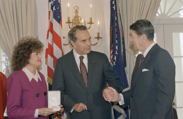 President Ronald Reagan shakes hands with then-Sen. Dole after presenting him with the Presidential Citizens Medal, which is held by Dole's wife, then-Labor Secretary-designate Elizabeth Dole, in 1989. (Photo: ASSOCIATED PRESS)