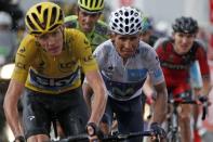 Team Sky rider Chris Froome of Britain (L), race leader's yellow jersey, and Movistar rider Nairo Quintana of Colombia (C) ride in the 195-km (121.16 miles) 12th stage of the 102nd Tour de France cycling race from Lannemezan to Plateau de Beille, in the French Pyrenees mountains, France, July 16, 2015. REUTERS/Benoit Tessier