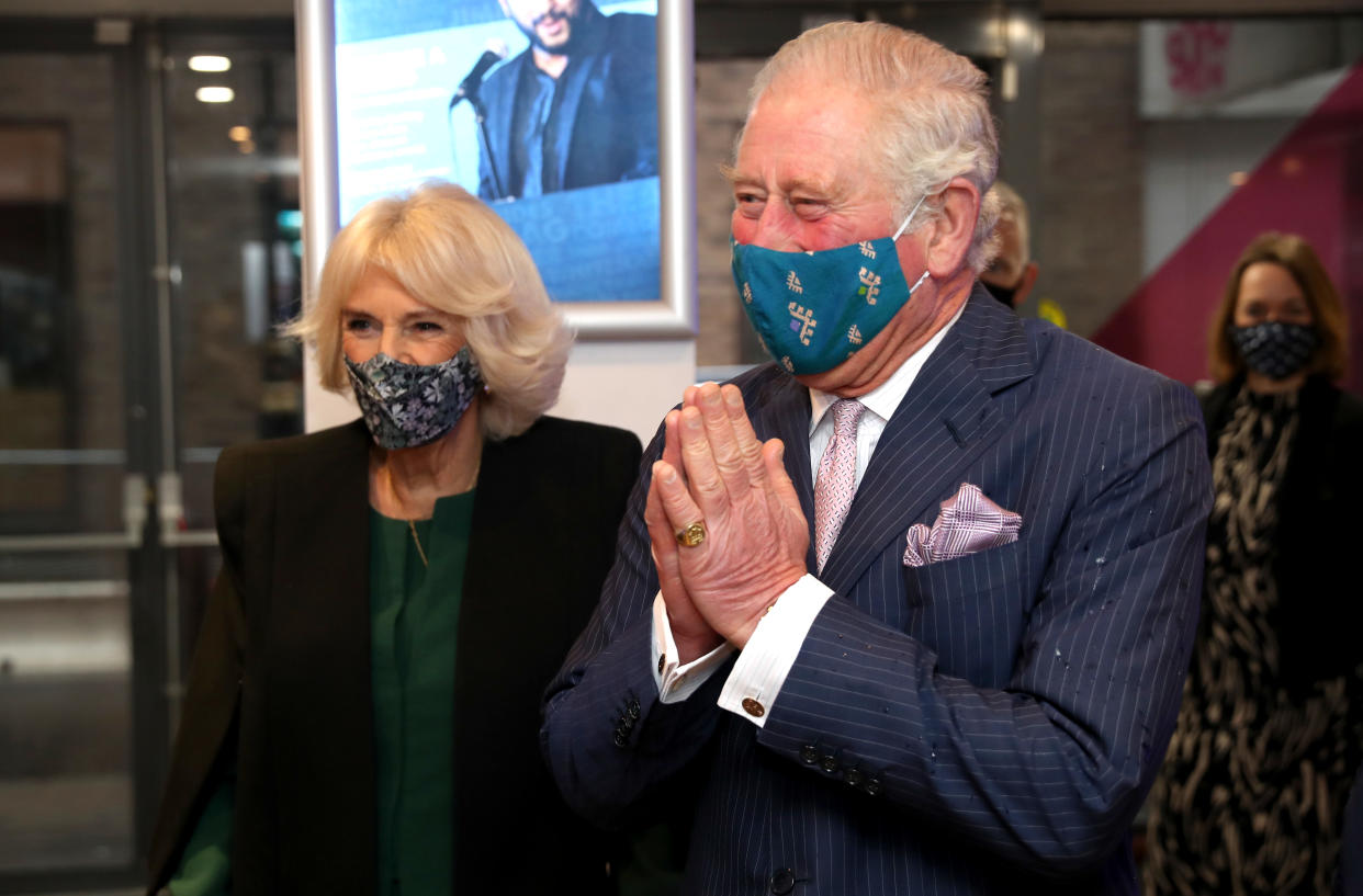LONDON, ENGLAND - DECEMBER 03: Prince Charles, Prince of Wales uses the traditional namaste greeting as he and Camilla, Duchess of Cornwall visit Soho Theatre to celebrate London's night economy on December 03, 2020 in London, England. (Photo by Chris Jackson - WPA Pool/Getty Images)