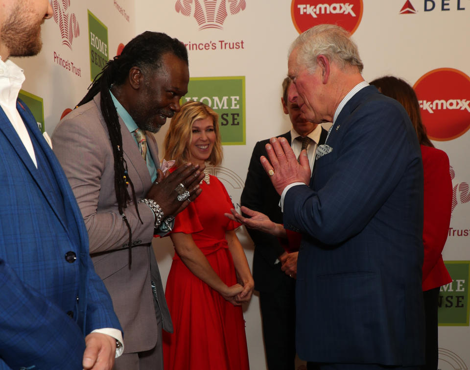 The Prince of Wales greets Levi Roots with a Namaste gesture as he arrives at the annual Prince's Trust Awards 2020 held at the London Palladium.