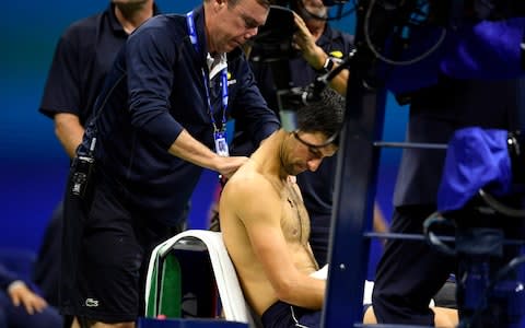 Novak Djokovic of Serbia has his shoulder worked on by an athletic trainer during a match against Stan Wawrinka of Switzerland in the fourth round on day seven of the 2019 US Open tennis tournament at USTA Billie Jean King National Tennis Center - Credit: &nbsp;USA TODAY Sports