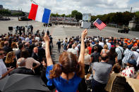 <p>A woman holds a French flag and an American flag during the traditional Bastille day military parade on the Champs-Elysees on July 14, 2017 in Paris France. Bastille Day, the French National day commemorates this year the 100th anniversary of the entry of the United States of America into World War I. (Photo: Thierry Chesnot/Getty Images) </p>