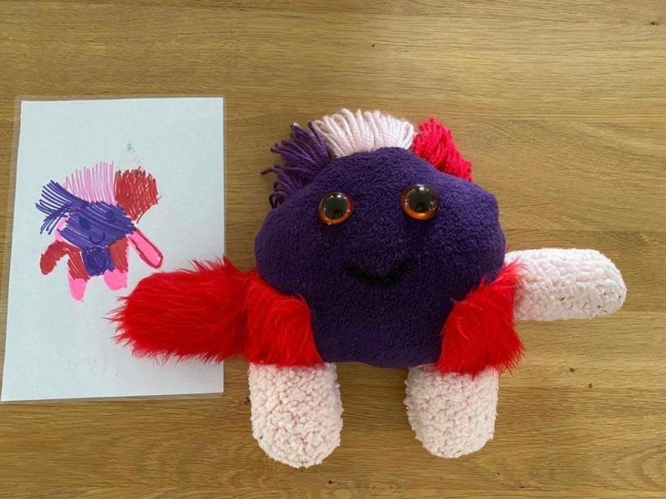 A drawing of a monster and the monster made into a toy that looks exactly like it