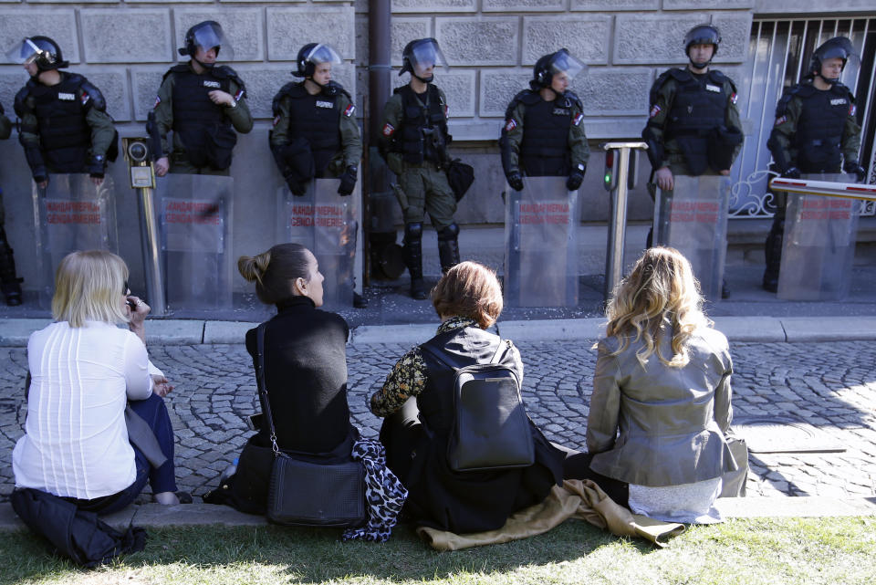 Serbian Gendarmerie members stand guard in front of the Serbian presidency building in Belgrade, Serbia, Sunday, March 17, 2019. As Serbian president Aleksandar Vucic held a news conference in the presidency building in downtown Belgrade, thousands of opposition supporters gathered in front demanding his resignation. Skirmishes with riot police were reported, including officers firing tear gas against the protesters who have pledged to form a human chain around the presidency to prevent Vucic from leaving the building. (AP Photo/Darko Vojinovic)