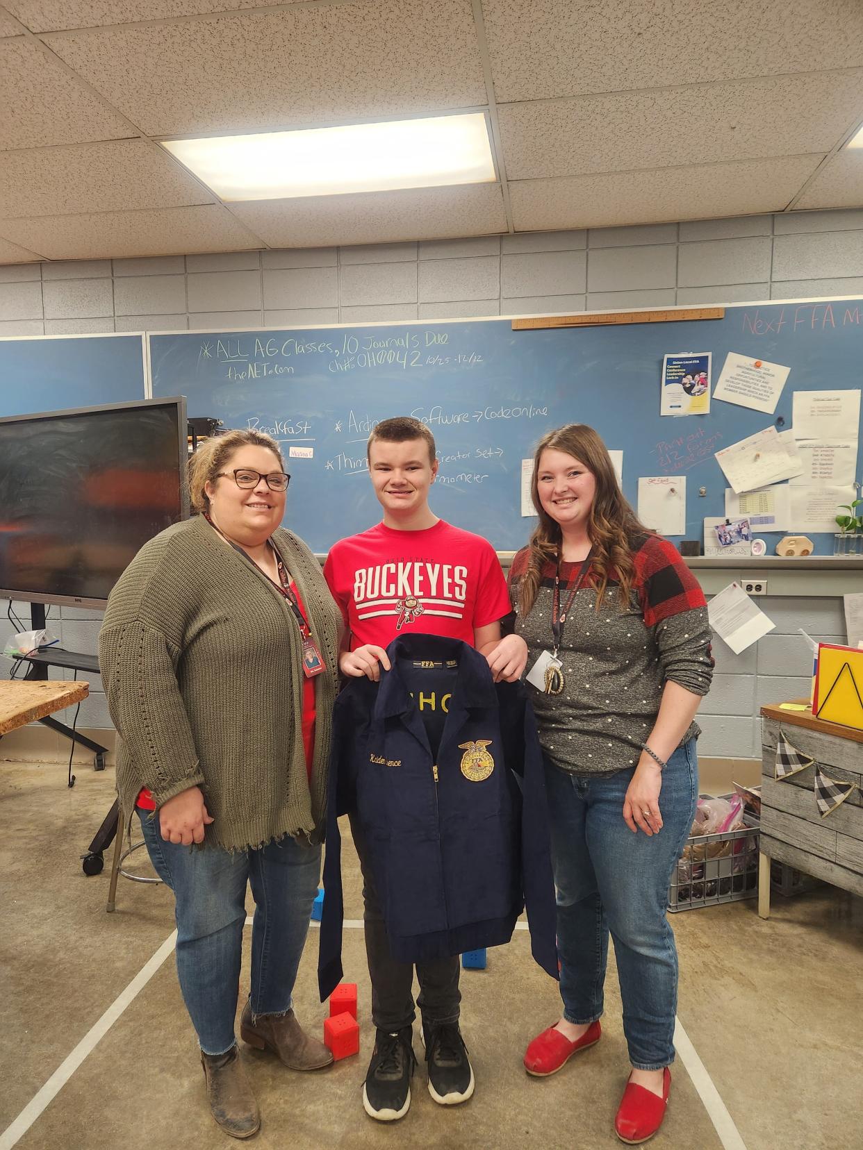 Suzanne Clark presents Kaiden Spence with his blue jacket with 
 Katrina Baker. Caldwell FFA Member Kaiden Spence was the recipient of a free FFA Jacket from the 2022 Ohio FFA Becks Blue Jacket Program. This year the program was able to provide roughly 200 jackets to FFA members across Ohio. Spence's jacket was sponsored by Cardinal Creeks Seeds located in Hicksville, OH.

 First-year FFA students could apply to the program or be nominated. Mrs. Suzanne Clark and Mrs. Katrina Baker nominated Spence for a jacket. They both agreed that Spence would cherish having a blue jacket of his own. Beyond its place in Official Dress, an FFA corduroy jacket is an article of faith, honor and pride. The jacket unifies members in a long-standing tradition and reminds them that they are part of something bigger than themselves. 

 The Caldwell FFA would like to congratulate Mr. Spence on this honor.