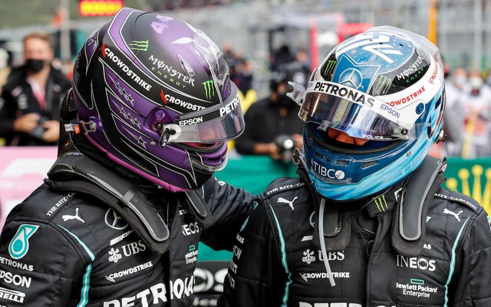 Mercedes' British driver Lewis Hamilton and Mercedes' Finnish driver Valtteri Bottas (R) greet each others after the qualifying sessions at the Intercity Istanbul Park in Istanbul on October 9, 2021, ahead of the Formula One Grand Prix of Turkey. - Lewis Hamilton dominated qualifying for the Turkish Grand Prix but his Mercedes team-mate Valtteri Bottas - AFP