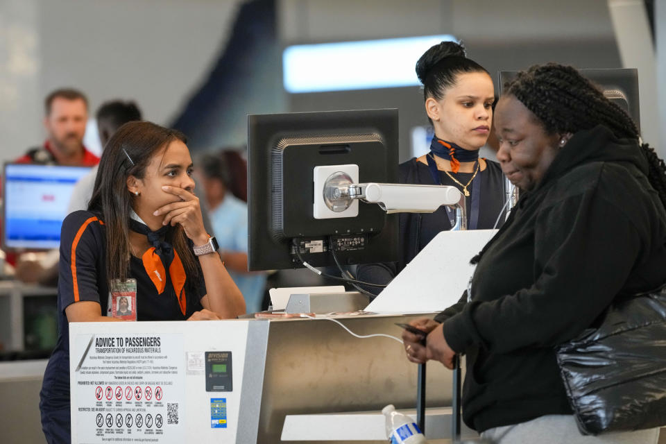 Jet Blue agents help a traveler, right, in the departures area of Terminal B at LaGuardia Airport, Tuesday, June 27, 2023, in New York. Travelers waited out widespread delays at U.S. airports on Tuesday, an ominous sign heading into the long July 4 holiday weekend, which is shaping up as the biggest test yet for airlines that are struggling to keep up with surging numbers of passengers. (AP Photo/Mary Altaffer)