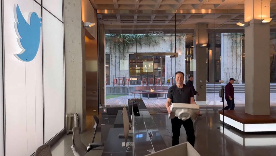 Elon Musk in an office building lobby