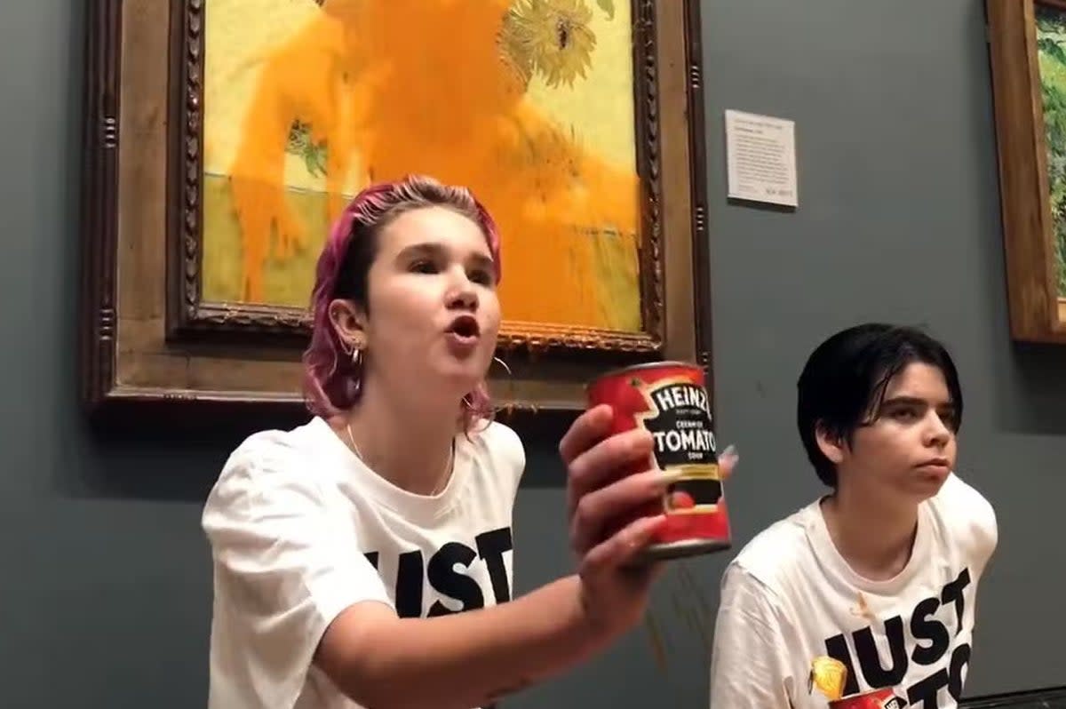 Two protesters have thrown tinned soup at Vincent Van Gogh's iconic work, Sunflowers, at the National Gallery, London (Just Stop Oil/PA )