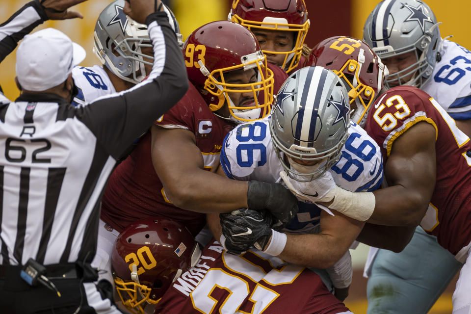 LANDOVER, MD - OCTOBER 25: Dalton Schultz #86 of the Dallas Cowboys recovers a fumble and is tackled for a safety by Chase Young #99, Jonathan Allen #93, Jon Bostic #53, and Jimmy Moreland #20 of the Washington Football Team during the first half at FedExField on October 25, 2020 in Landover, Maryland. (Photo by Scott Taetsch/Getty Images)