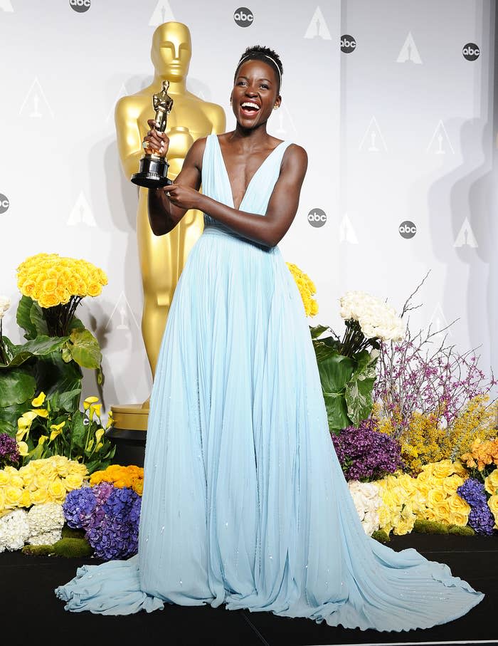 Nyong'o holding her Oscar in 2014