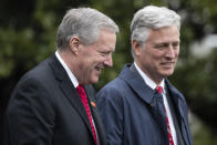 Acting White House Chief of Staff Mark Meadows, left, walks with National Security Adviser Robert O'Brien to join President Donald Trump on Marine One as he departs the White House, Saturday, March 28, 2020, in Washington. Trump is en route to Norfolk, Va., for the sailing of the USNS Comfort, which is headed to New York. (AP Photo/Alex Brandon)