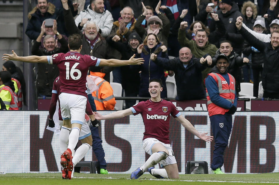 West Ham's Declan Rice, right, celebrates after scoring the opening goal during the English Premier League soccer match between West Ham United and Arsenal at London Stadium in London, Saturday, Jan. 12, 2019. (AP Photo/Tim Ireland)