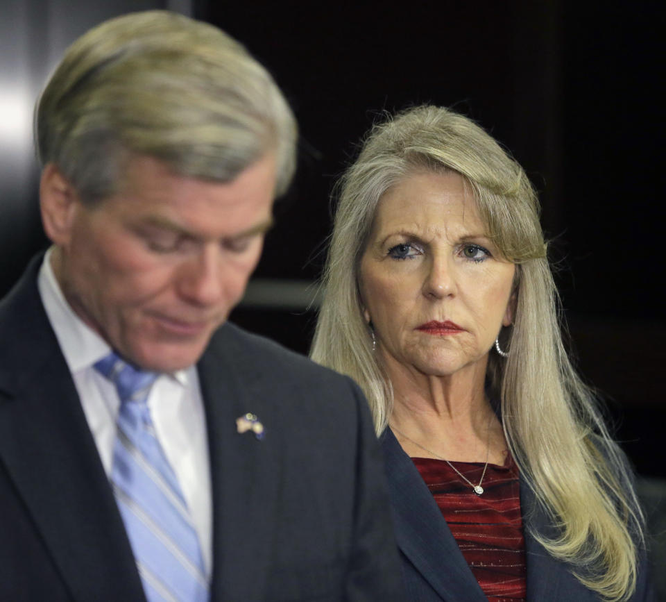 Former Virginia Gov. Bob McDonnell pauses while making a statement as his wife, Maureen, right, listens during a news conference in Richmond, Va., Tuesday, Jan. 21, 2014. McDonnell and his wife were indicted Tuesday on corruption charges after a monthslong federal investigation into gifts the Republican received from a political donor. (AP Photo/Steve Helber)