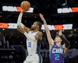 Orlando Magic guard Terrence Ross (31) makes a jumper as Charlotte Hornets guard LaMelo Ball (2) attempts the block from behind during the first half of an NBA basketball game on Friday, Jan. 14, 2022, in Charlotte, N.C. (AP Photo/Rusty Jones)